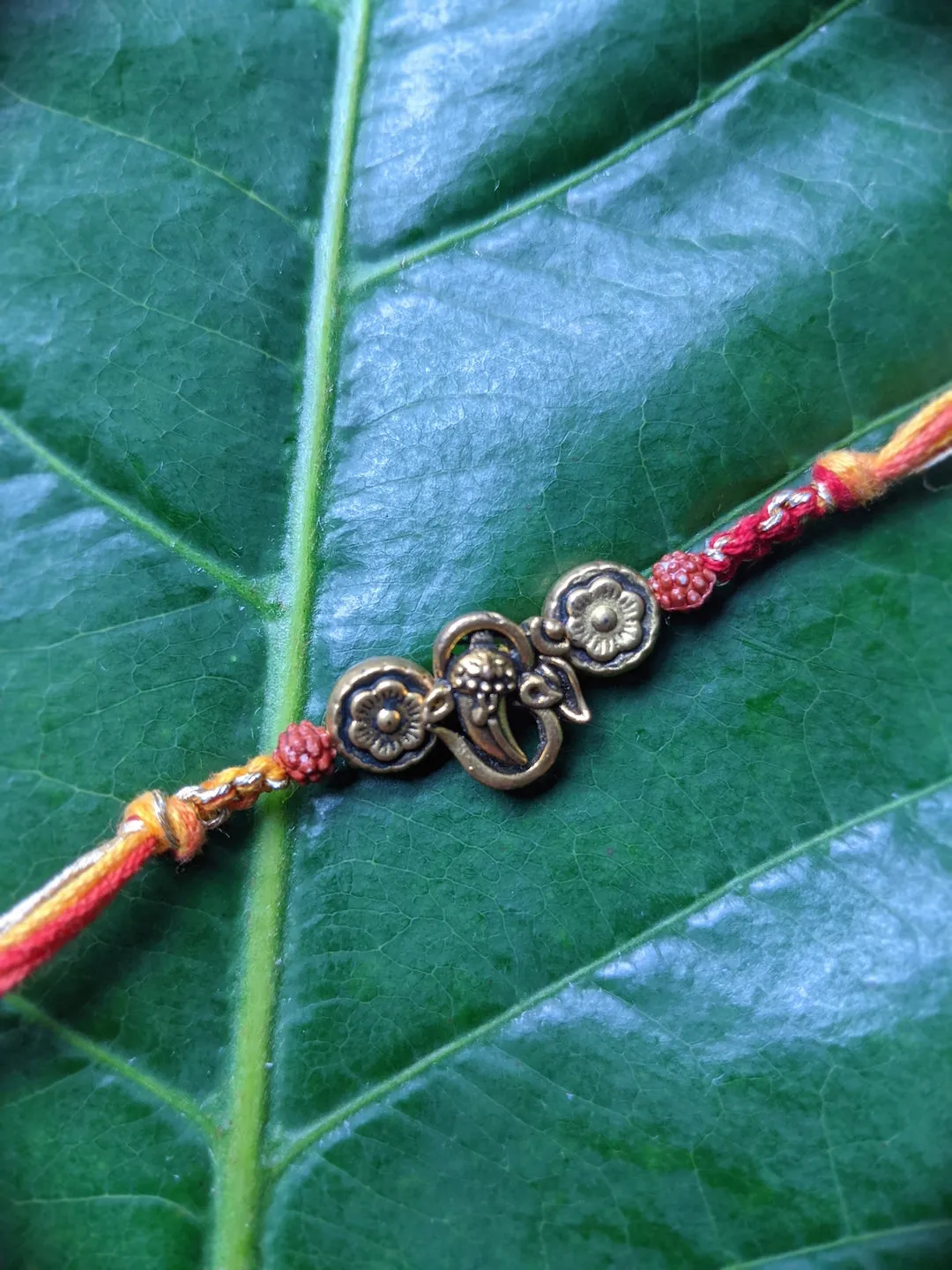 Fancy Rakhi Designs Ganesh Ji Pendant with Rudhraksha Multicoloured Mauli Raksha Bandhan