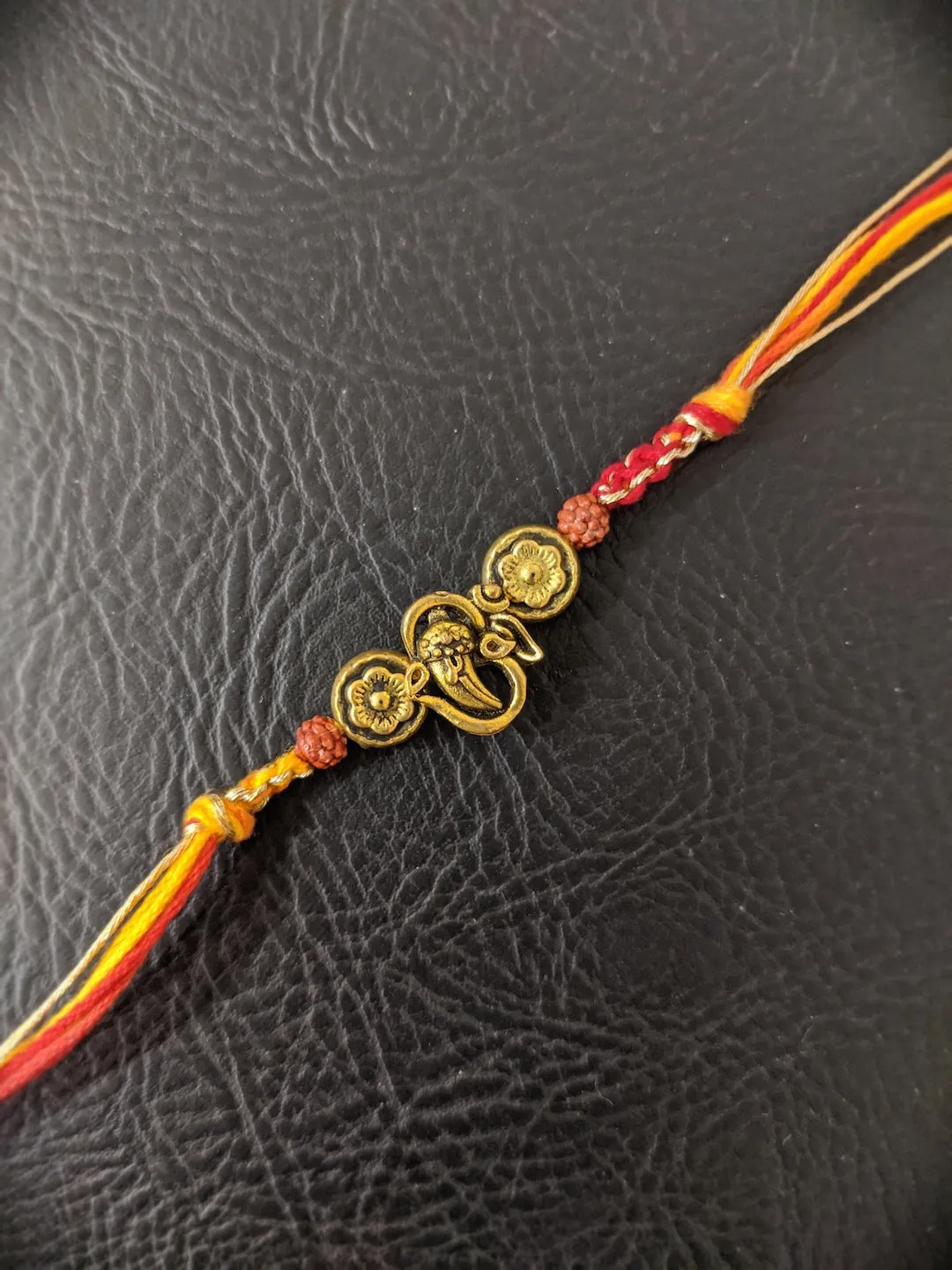 Fancy Rakhi Designs Ganesh Ji Pendant with Rudhraksha Multicoloured Mauli Raksha Bandhan
