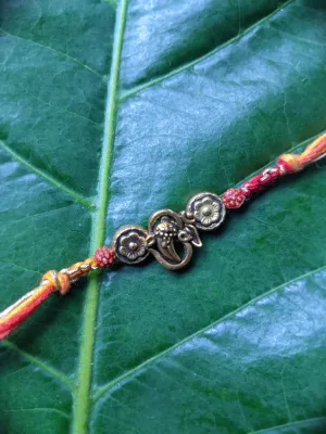Fancy Rakhi Designs Ganesh Ji Pendant with Rudhraksha Multicoloured Mauli Raksha Bandhan