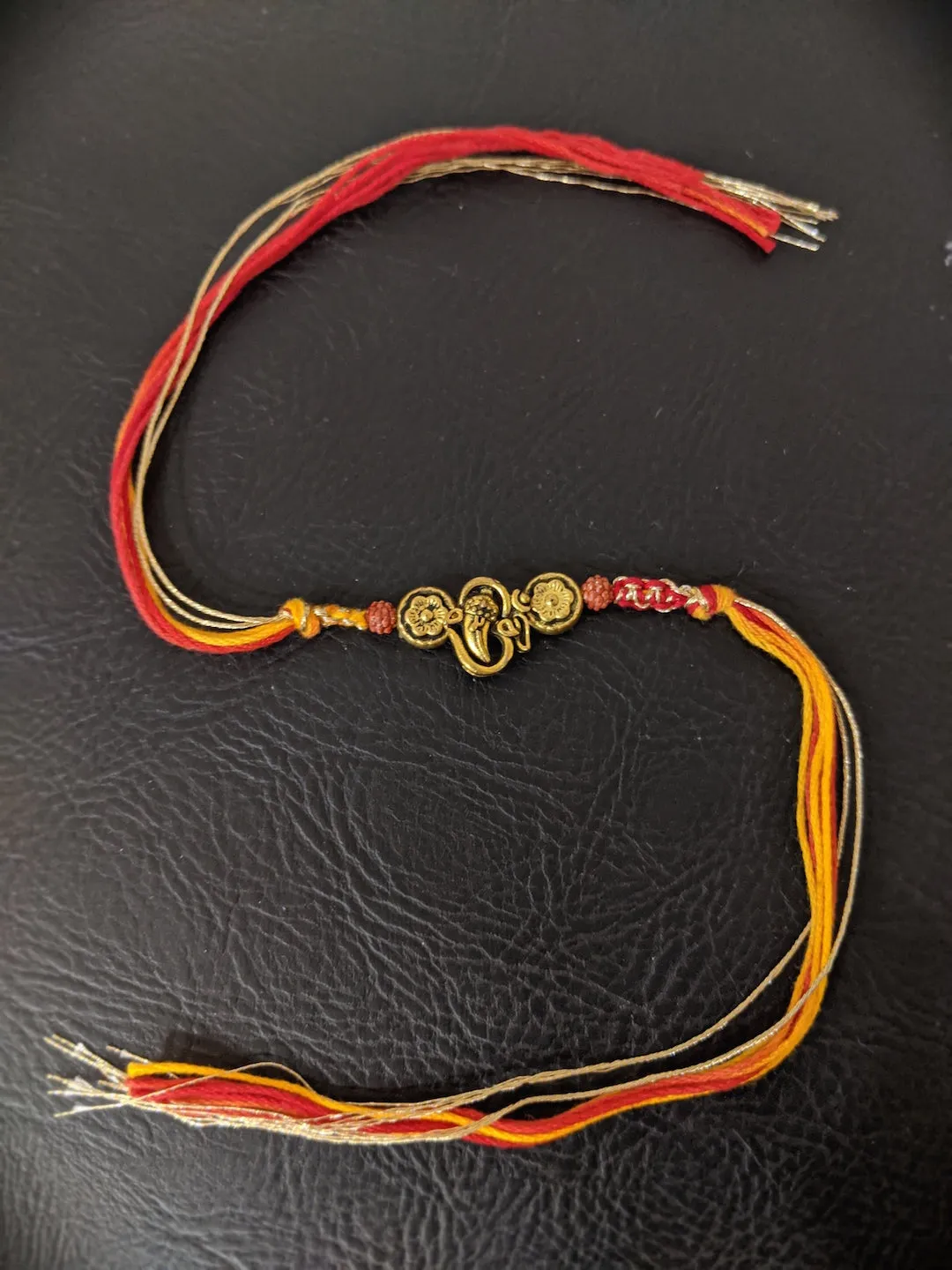 Fancy Rakhi Designs Ganesh Ji Pendant with Rudhraksha Multicoloured Mauli Raksha Bandhan
