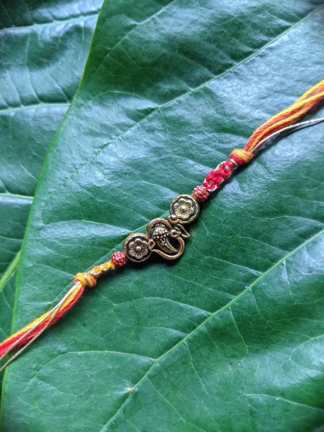 Fancy Rakhi Designs Ganesh Ji Pendant with Rudhraksha Multicoloured Mauli Raksha Bandhan