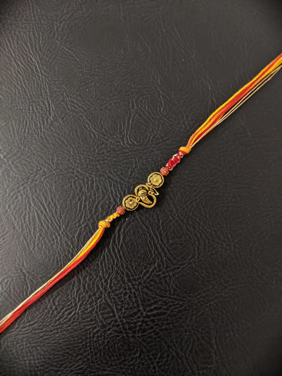 Fancy Rakhi Designs Ganesh Ji Pendant with Rudhraksha Multicoloured Mauli Raksha Bandhan