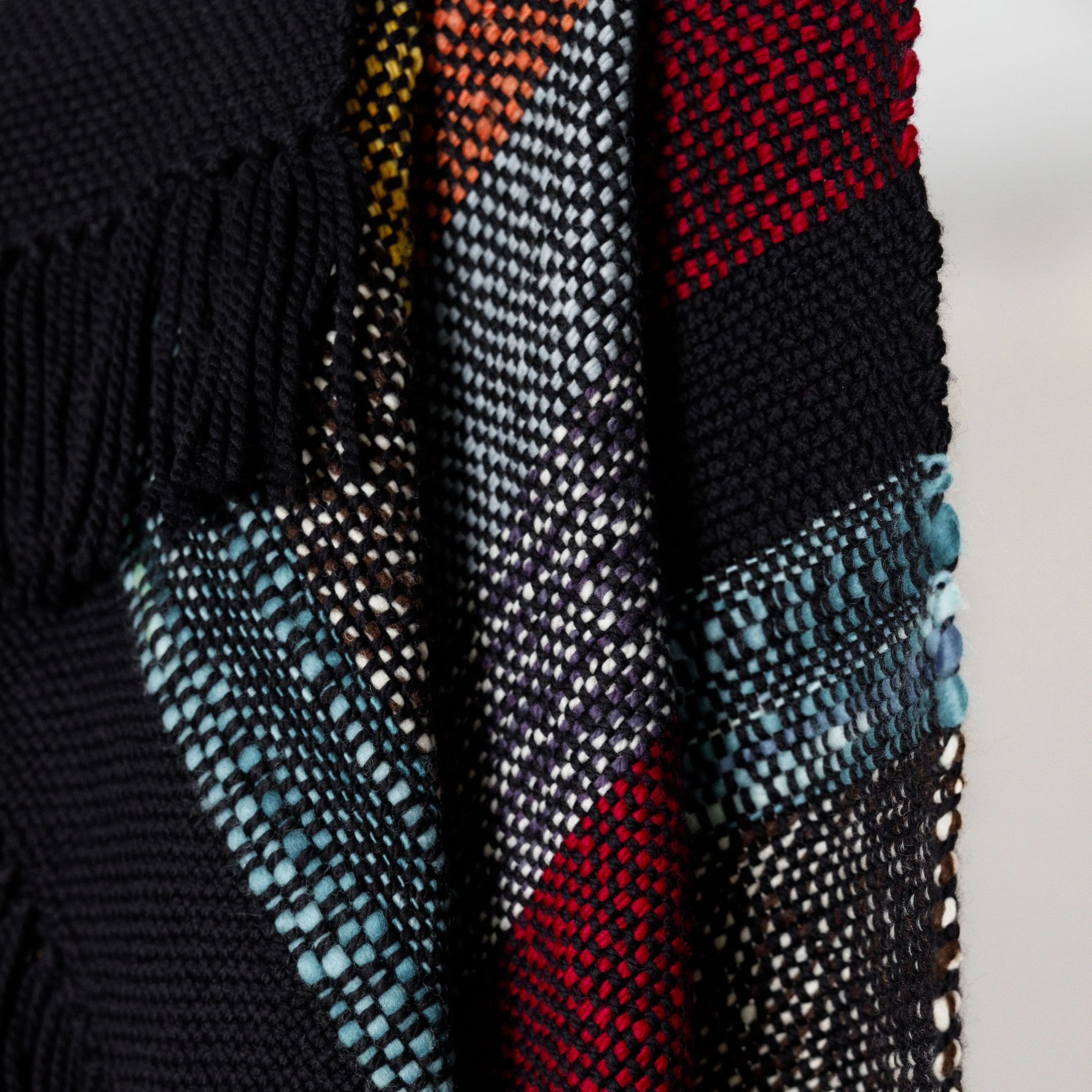 Handwoven Merino Wool Blanket – Black Base with Vibrant Stripes and Fringes