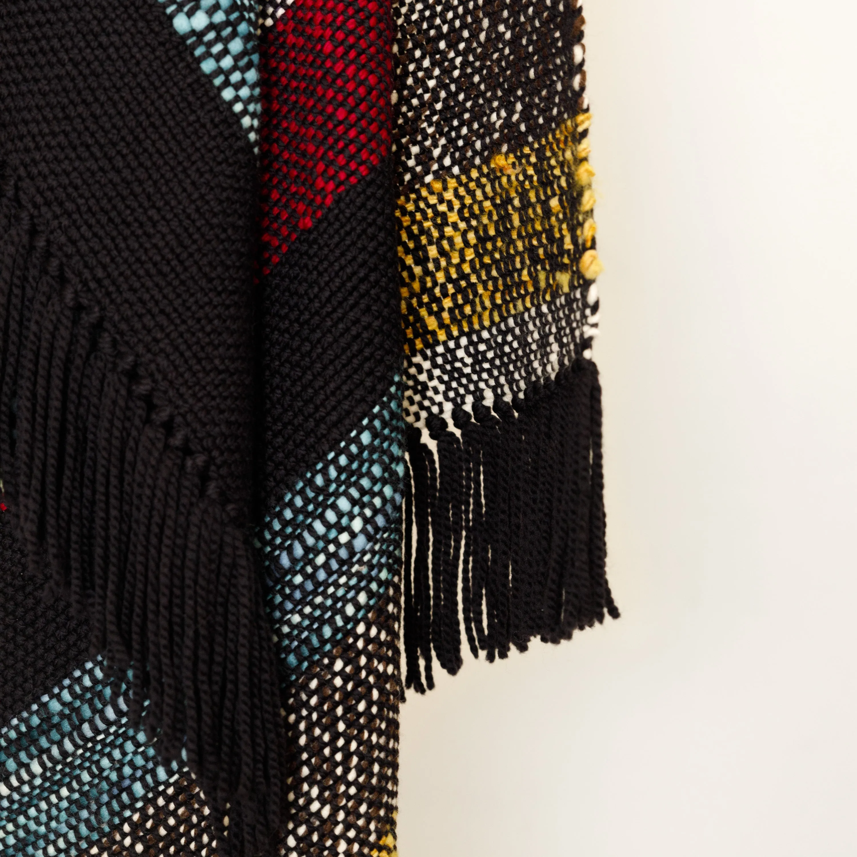 Handwoven Merino Wool Blanket – Black Base with Vibrant Stripes and Fringes