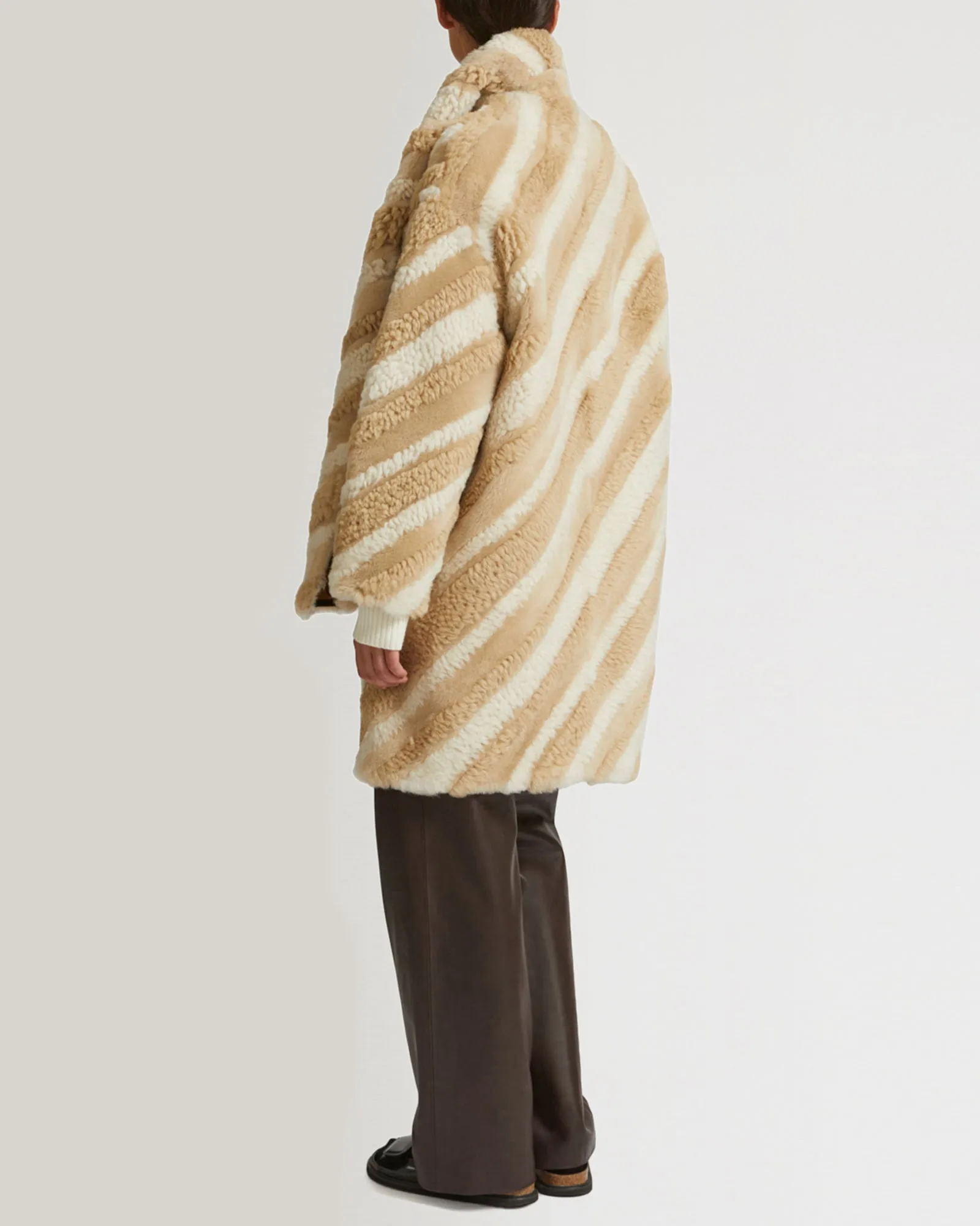 Long coat in curly merino wool and shearling